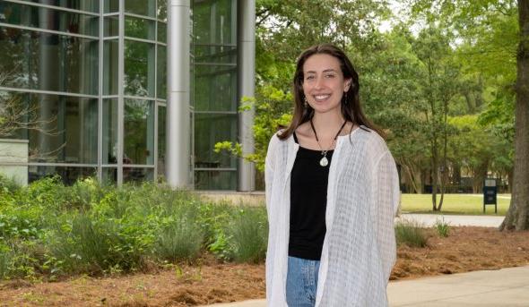 Photo of a female student standing on ODU’s campus. 