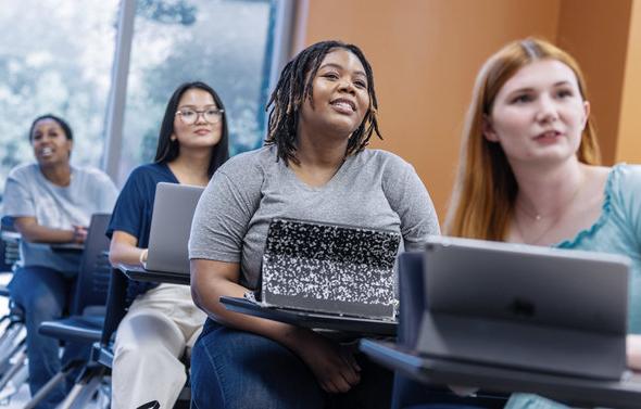 Students in a classroom, watching a lecture