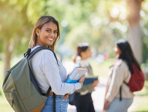 Student with books on campus